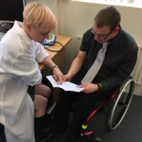 Doctor and patient reading a leaflet