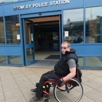 A wheelchair-using man outside Bromley Police Station
