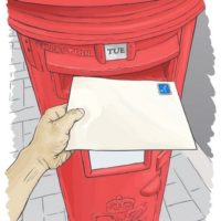 Hand posting a blank, unaddressed letter into a red postbox