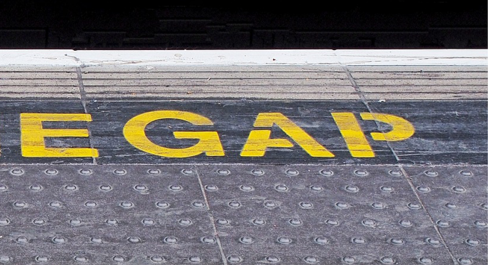 Photo of part of a "Mind the Gap" sign on a station platform