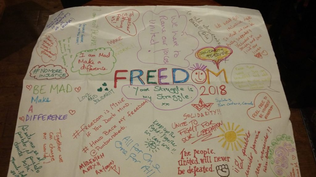 Piece of paper with the word 'FREEDOM 2018' in the middle and other messages around it