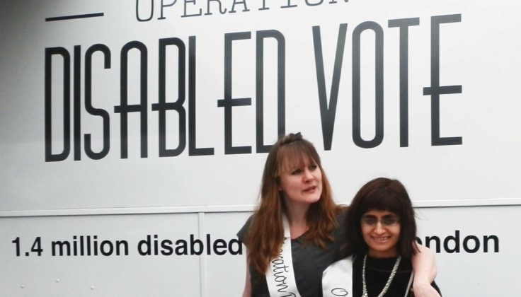 The image shows two individuals posing for a photo in front of a sign that reads "OPERATION DISABLED VOTE". Below this text is a statistic mentioning "1.4 million disabled in London," indicating a campaign or initiative to encourage voting among disabled individuals in London. The two individuals are smiling and one of them is wearing a sash, which suggests an event or promotion related to the campaign. The sign's bold, capitalized lettering is designed to catch the eye and emphasize the importance of the disabled vote, potentially as part of a larger effort to increase electoral participation within the disabled community.
